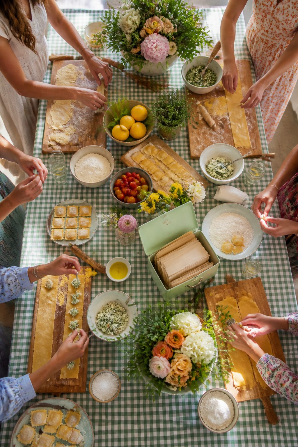 Guests bring kitchen-related gifts for a bridal shower.