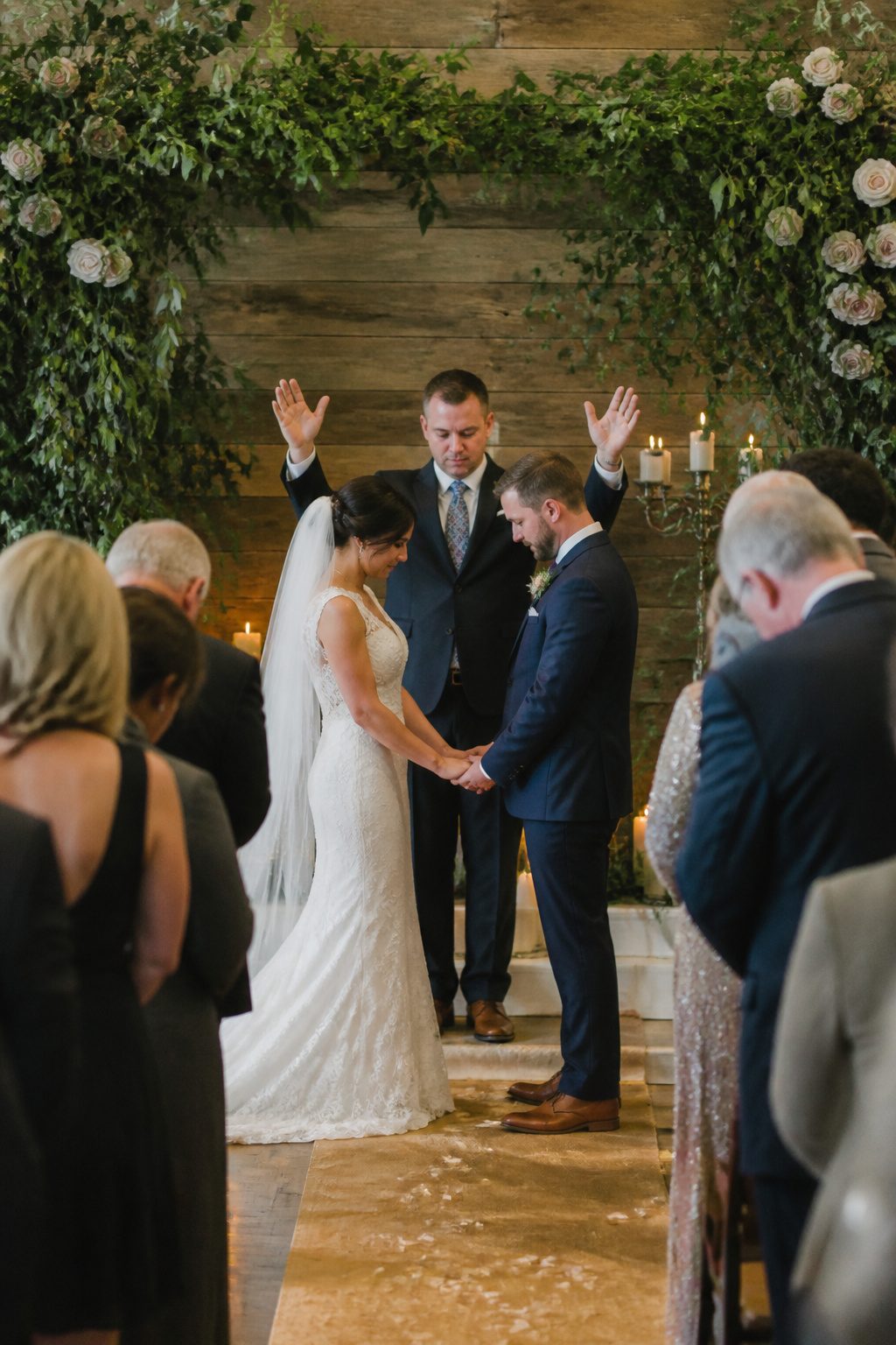 Officiant praying with the couple and congregation.