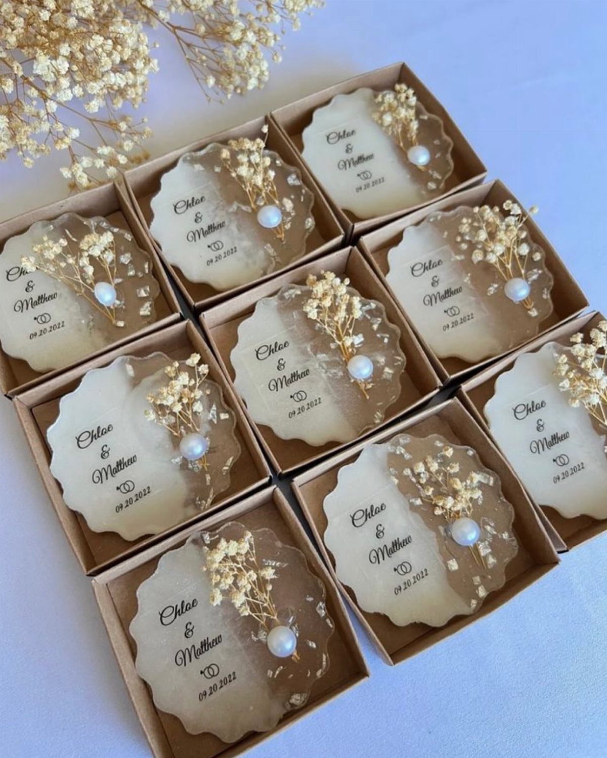 13 Cute and Fun Wedding Ideas for Guests Your Guests Will Love 5 Personalised resin coasters with dried flowers and pearls arranged in small gift boxes.