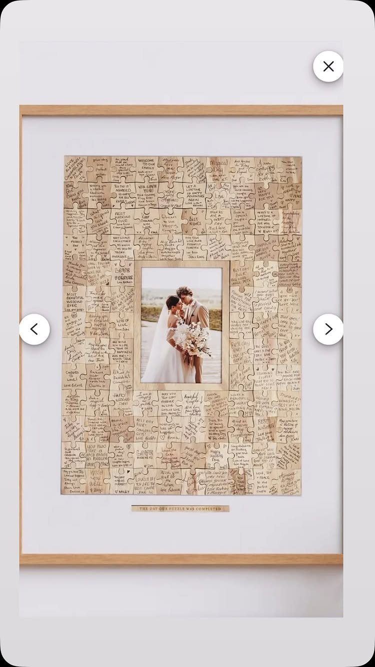 Framed wedding photo surrounded by handwritten jigsaw puzzle pieces as a guest book.