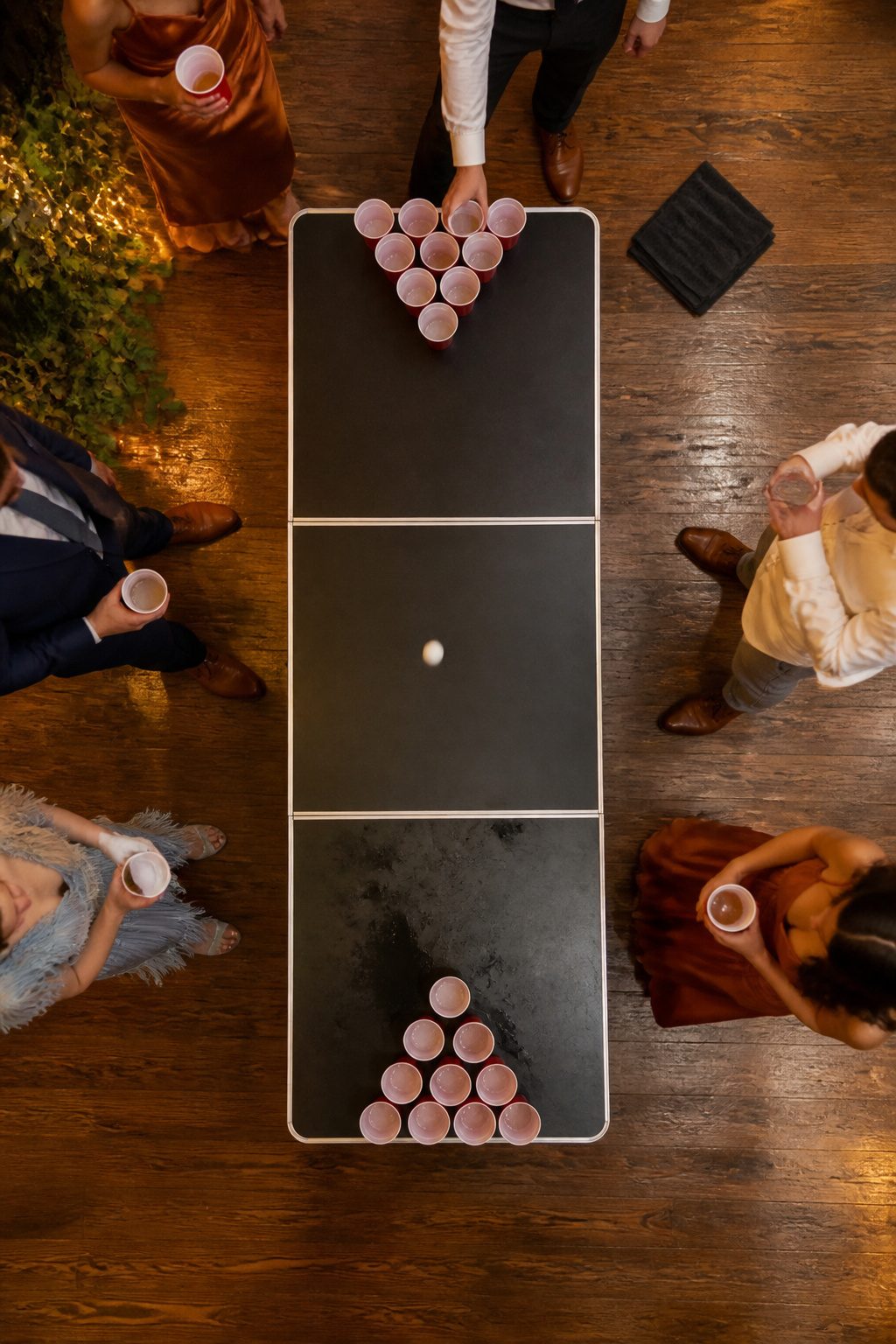 A beer pong table set up at a wedding reception.