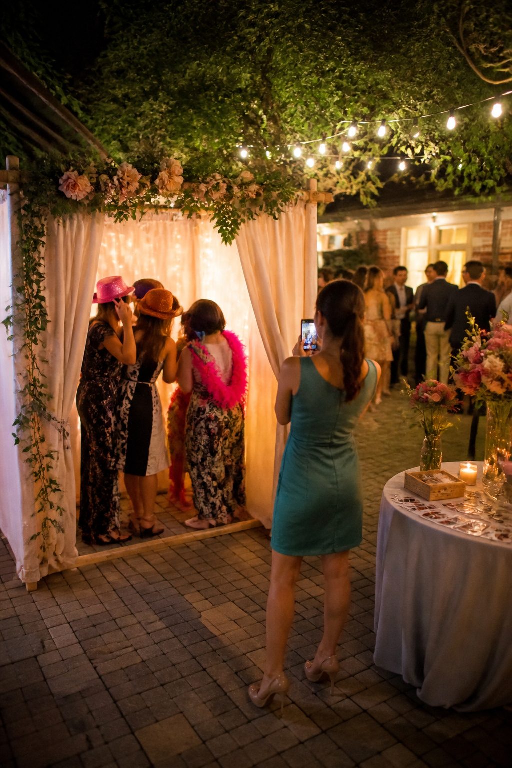 An open-air photo booth with props at a wedding.