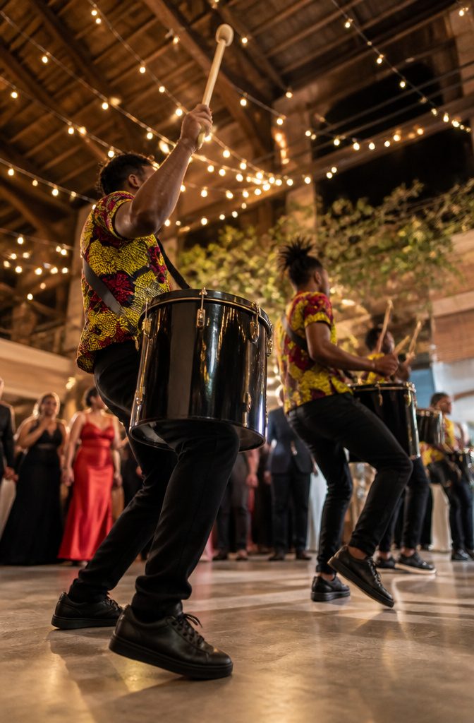 Stilt walkers performing during cocktail hour at a wedding reception.
