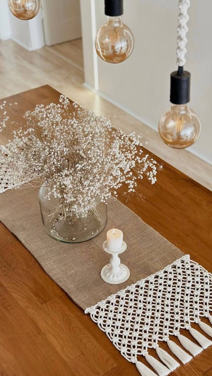 10 Lace and Greenery Wedding Table Ideas to Try 10 White baby's breath in a glass vase on a burlap and macrame table runner.