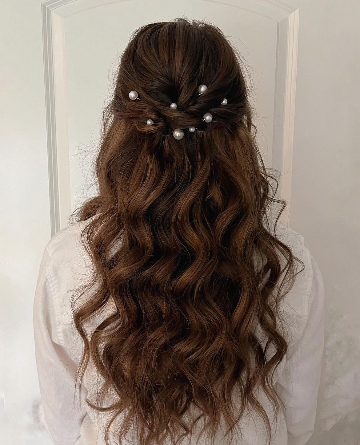 Long Hair Half Up for Wedding: 10 Styles That Work 10 Long wavy brown hair in a half-updo decorated with small white pearls.