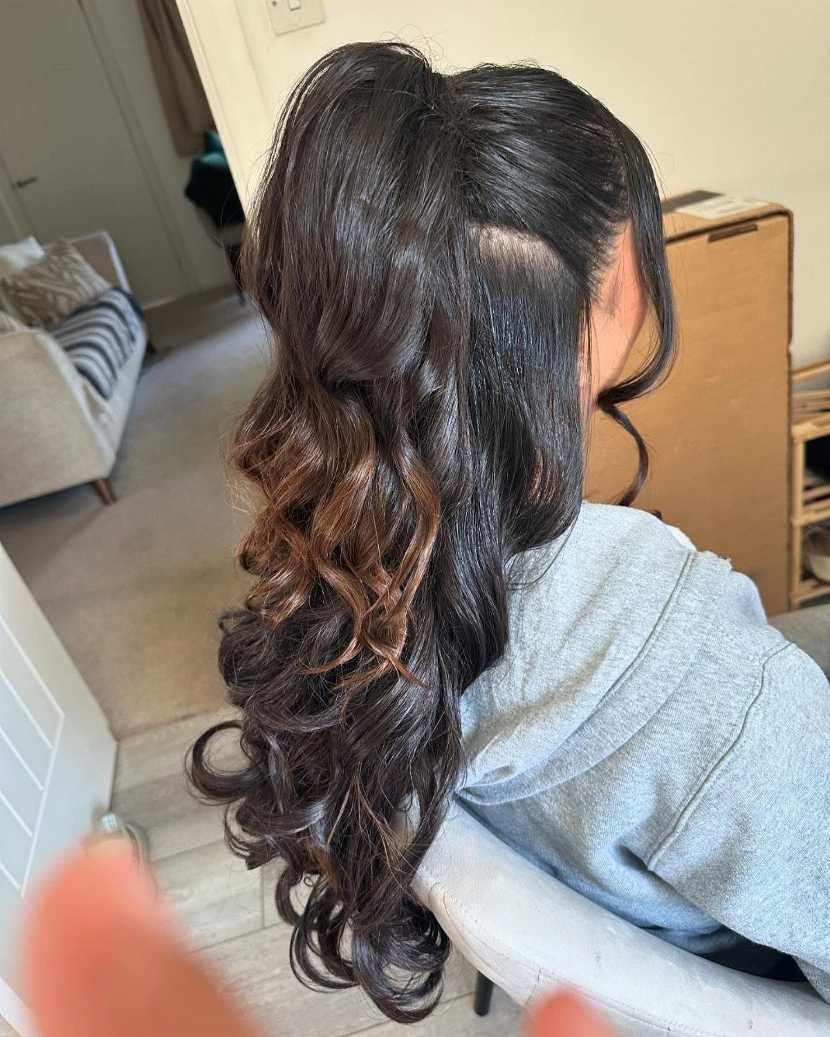 Long Hair Half Up for Wedding: 10 Styles That Work 7 Woman with long dark hair styled in a half-up ponytail with voluminous curls.