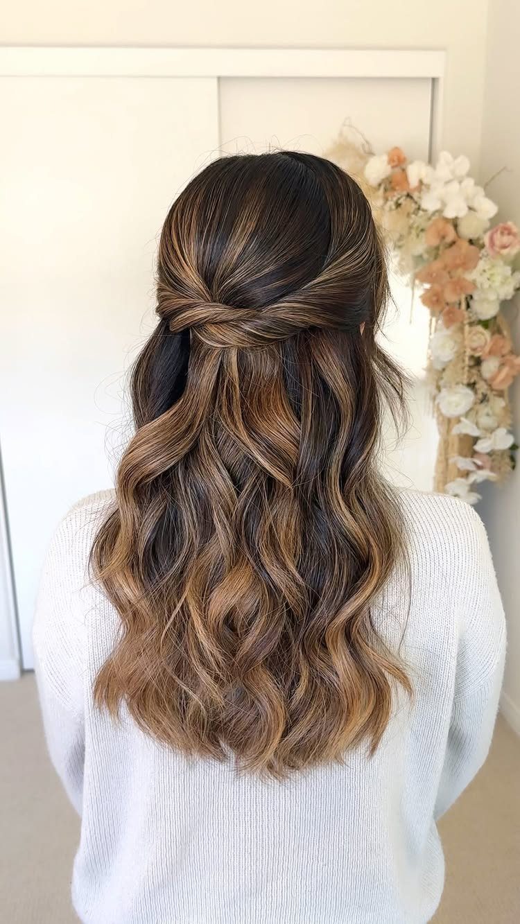 Long Hair Half Up for Wedding: 10 Styles That Work 1 Long wavy brown hair styled in a twisted half-updo seen from behind.