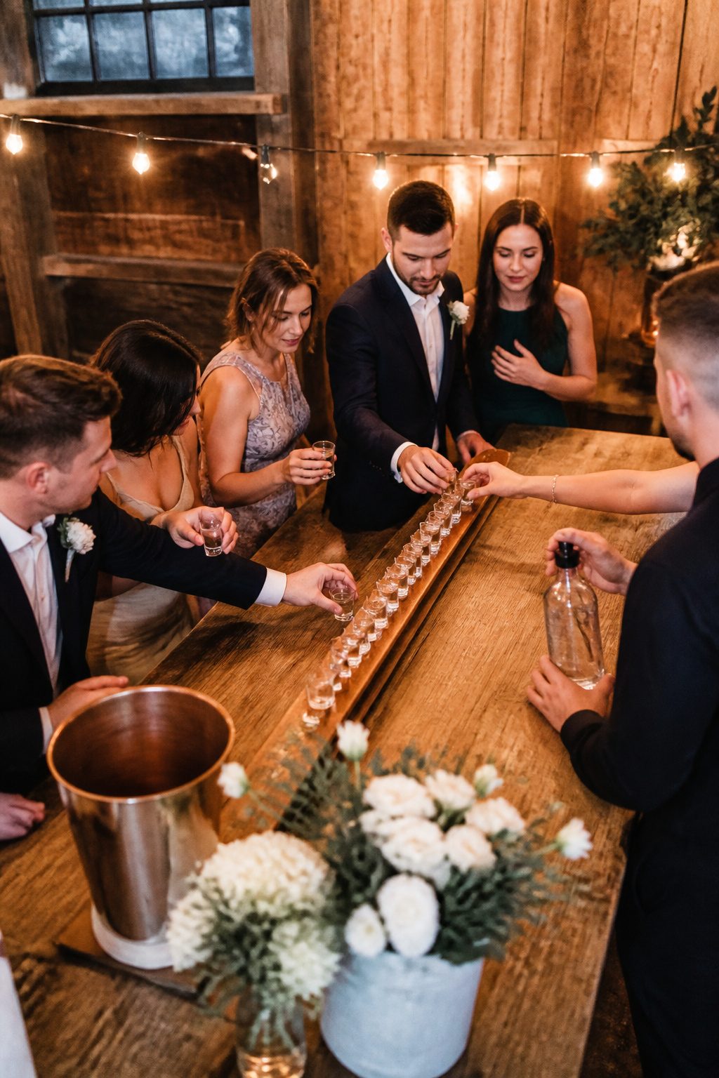 Vintage wooden ski with shot glasses at a wedding.