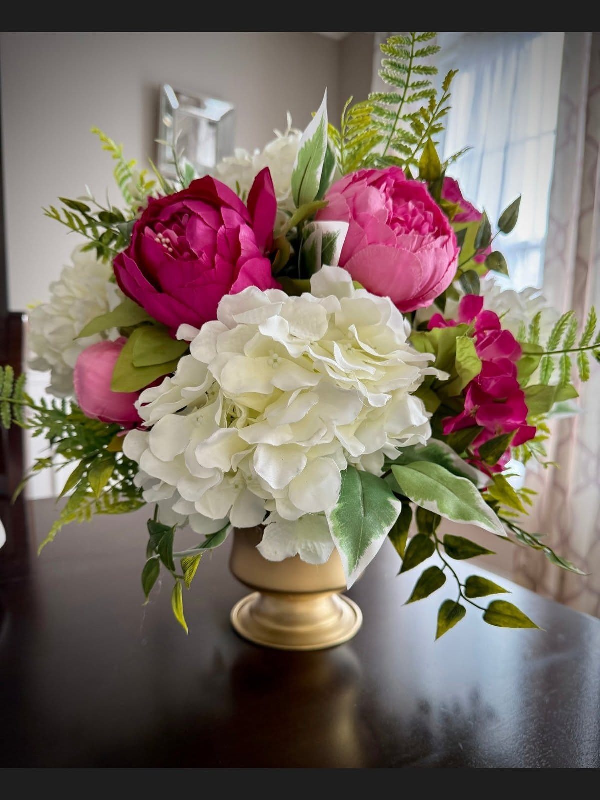 8 Simple Wedding Centerpieces for Budget-Friendly Tables 5 Pink peonies and white hydrangeas arranged with greenery in a gold pedestal vase.