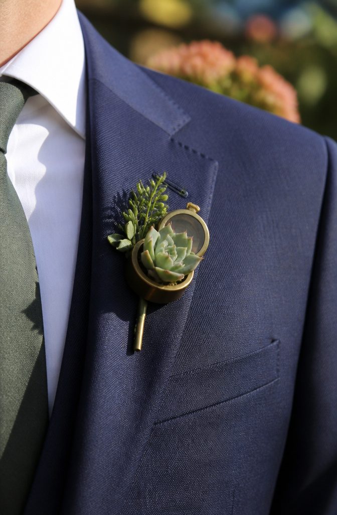 20 Special Wedding Ideas for a 2026 Celebration You'll Remember 14 A close-up of a groomsman's lapel with a succulent boutonniere.