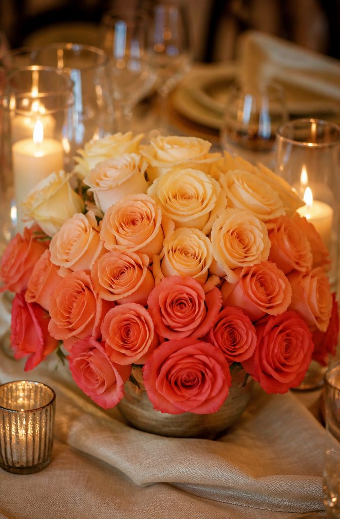 20 Wedding Decor Centerpiece Ideas for Every Reception Table 11 A row of roses arranged in a sunset gradient from dark to light.