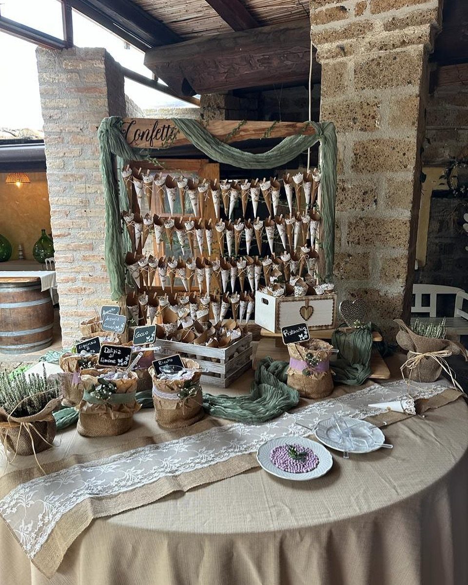 20 Wedding Decor DIY Ideas for Ceremony and Reception 13 A rustic wooden display filled with small paper cones of confetti on a decorated wedding table.