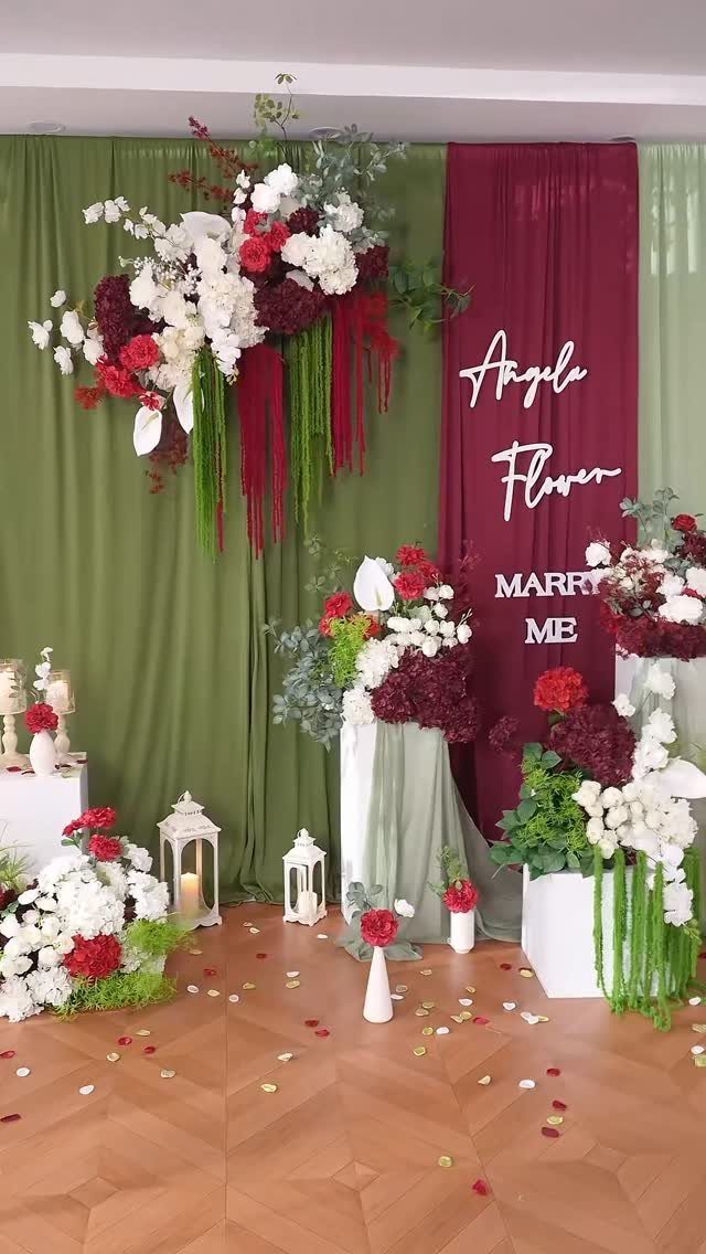 20 Wedding Decor DIY Ideas for Ceremony and Reception 1 Large white and red floral arrangements set against green and burgundy fabric backdrops.