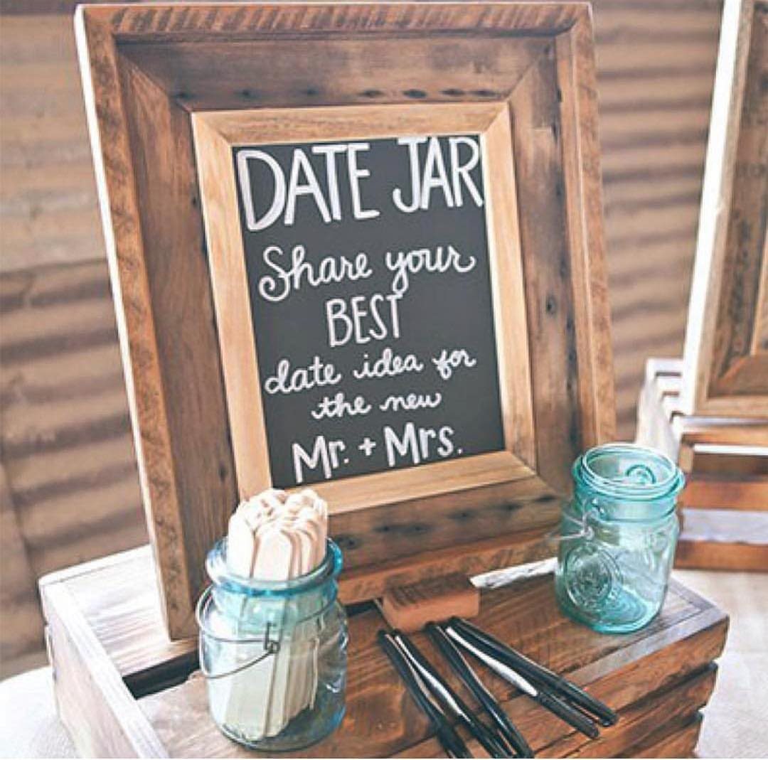 20 Wedding Decor DIY Ideas for Ceremony and Reception 9 A wooden framed chalkboard sign and blue mason jars on a rustic wooden crate.
