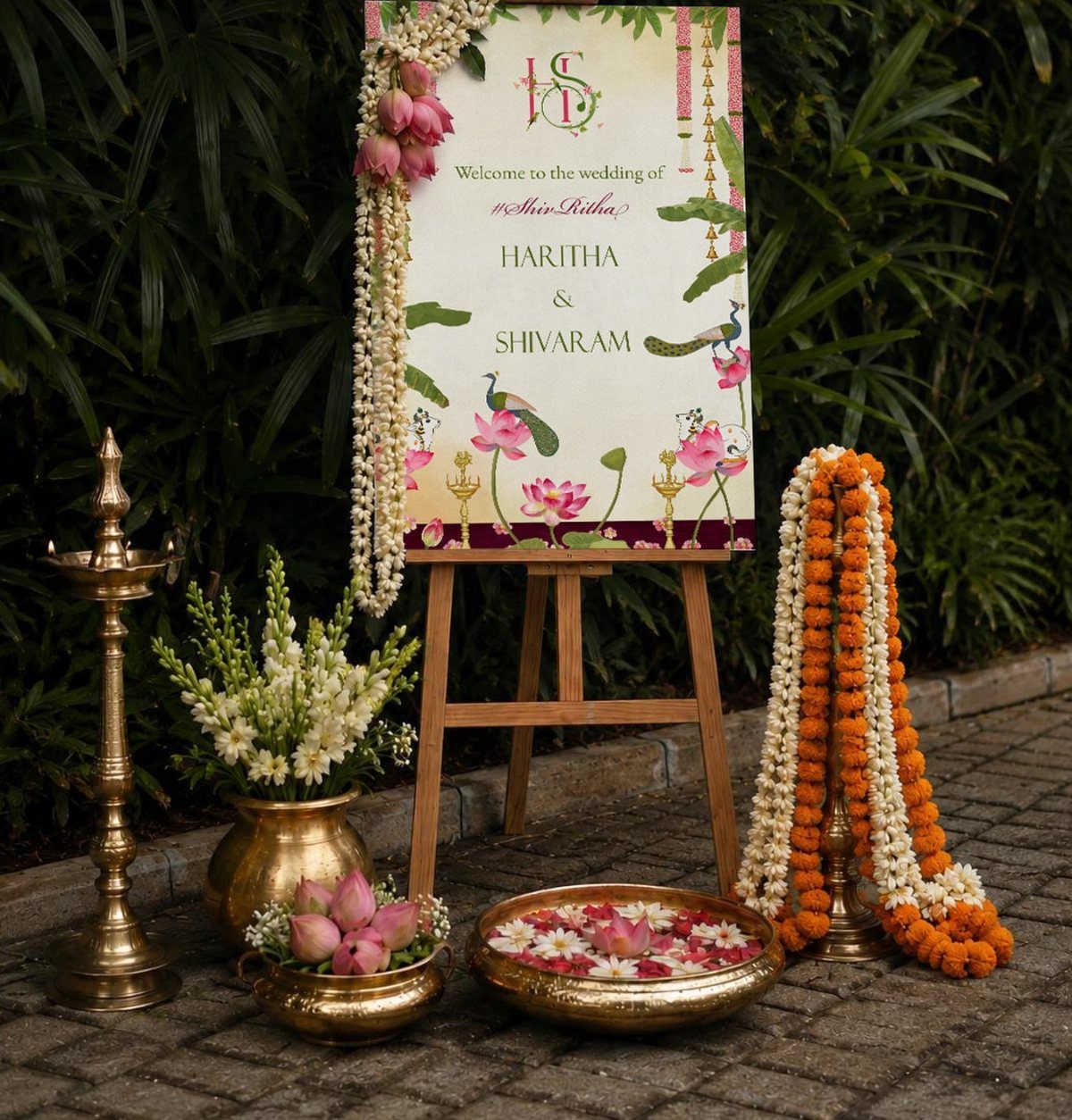 20 Wedding Decor DIY Ideas for Ceremony and Reception 18 A wedding welcome sign on an easel surrounded by brass lamps and floral arrangements.