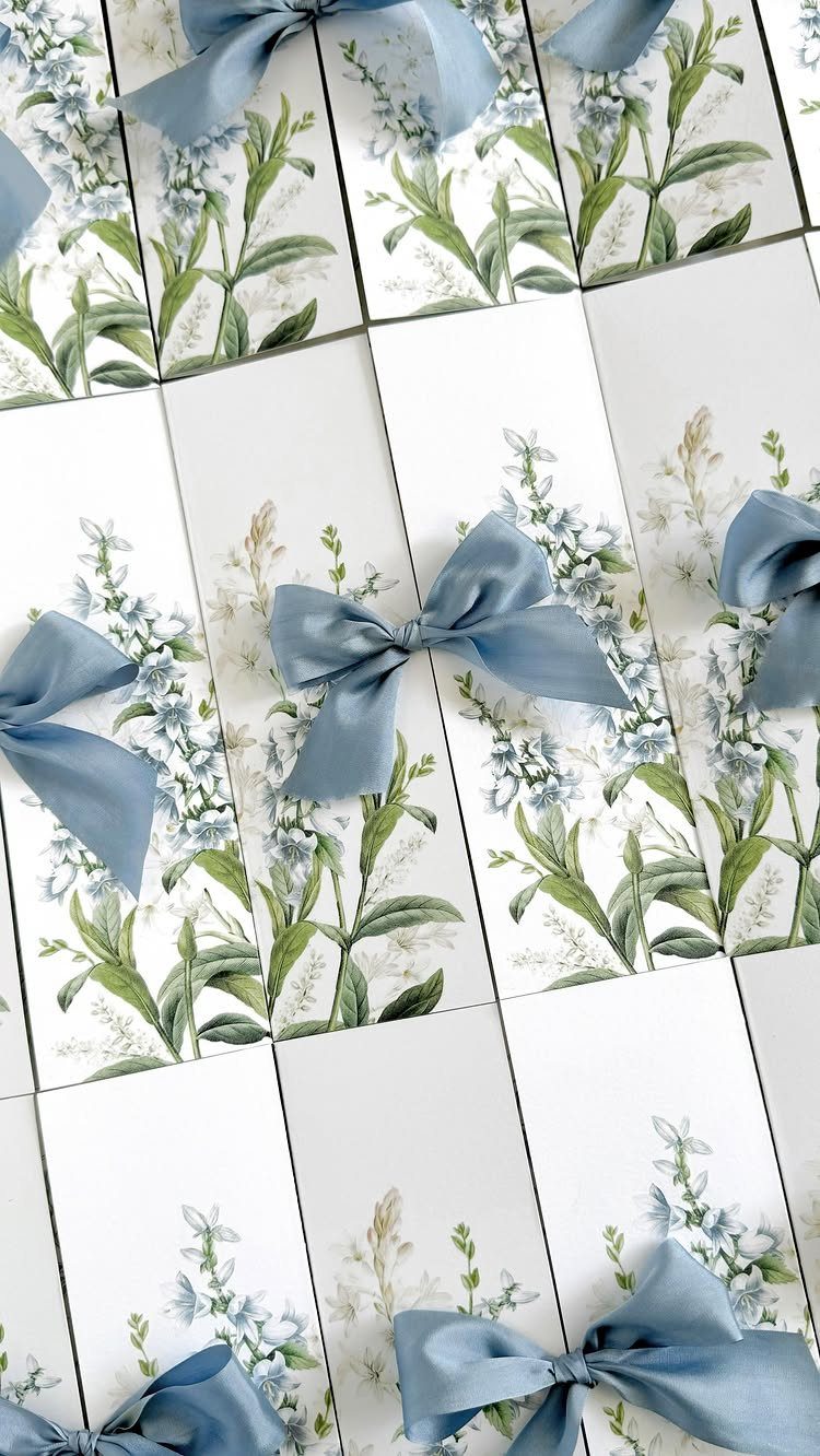 22 Wedding Decor Garden Theme Ideas for Every Reception Style 9 Botanical wedding invitations with blue floral illustrations and matching blue satin bows.