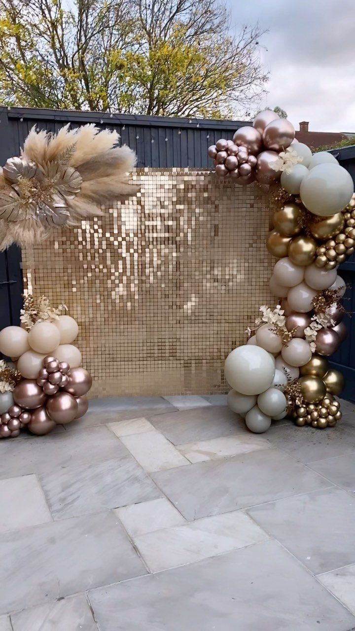 Wedding Decor and Themes: 12 Ideas From Beach to Garden 7 Gold sequin shimmer wall surrounded by champagne and white balloon arches on a stone patio.