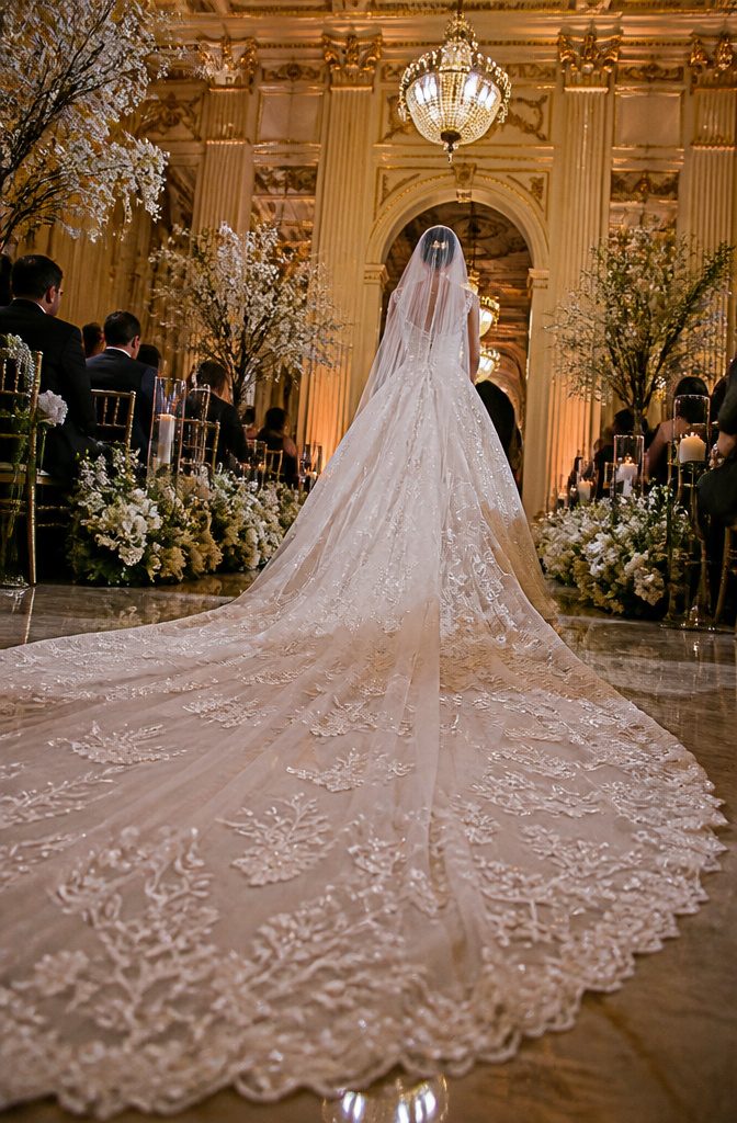 Wedding Dress Long Train: A Guide to Train Styles and Lengths 7 Bride showcasing a long monarch train in a grand venue.