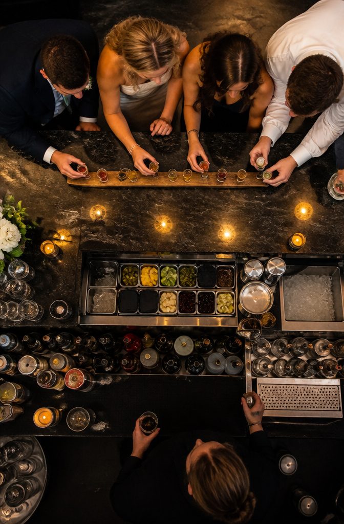 20 Wedding Reception Ideas for a 2026 Party Guests Won't Forget 14 A ski shot setup with shot glasses and guests preparing to drink.