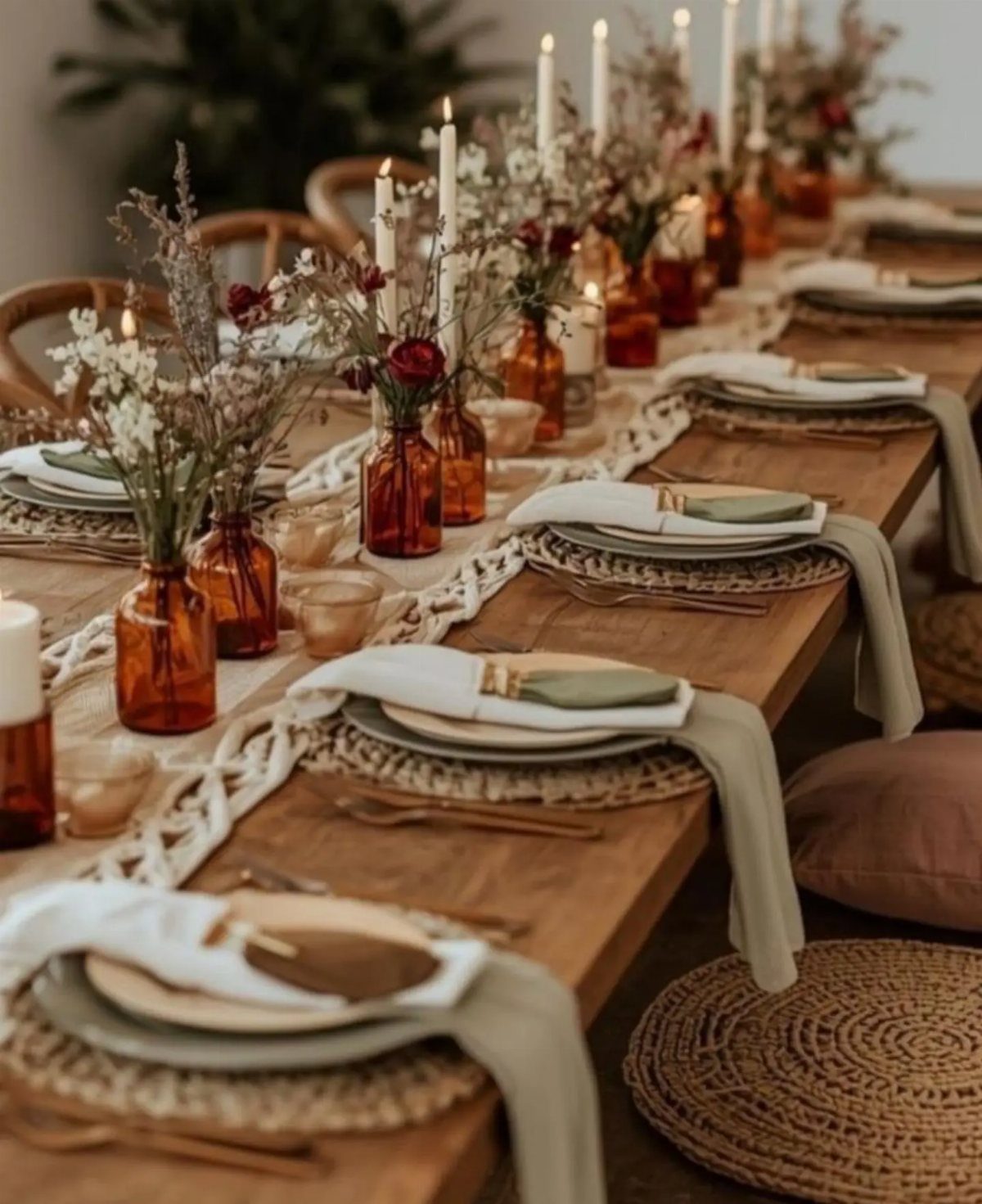 11 Wedding Party Table Decor Ideas for Any Venue Style 6 A rustic wedding table setting with amber glass vases, wildflowers, taper candles, and macrame runner.