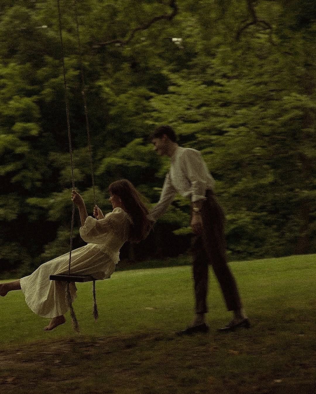 9 Wedding Photos Poses for Every Part of Your Day 9 A woman in a white dress sits on a rope swing in a green forest.