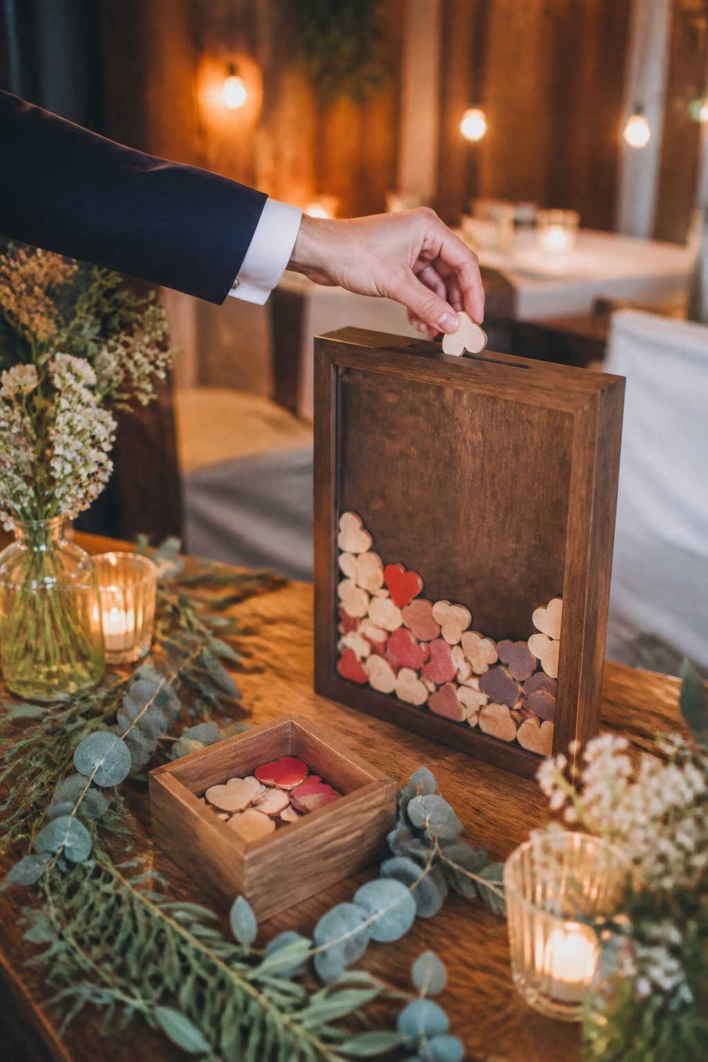 20 Wedding Sign In Ideas Guest Books Couples Actually Keep 12 A shadow box filled with signed wooden hearts at a wedding.