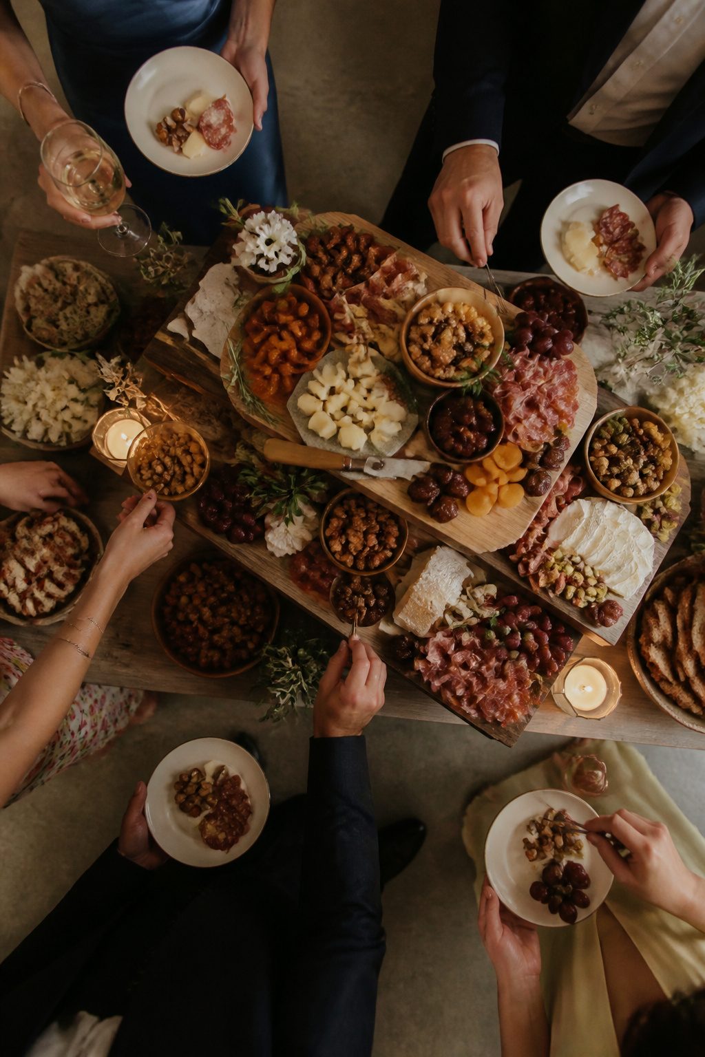 24 Wedding Station Ideas for 2026 Receptions 15 A selection of cheeses and meats arranged on wooden boards.