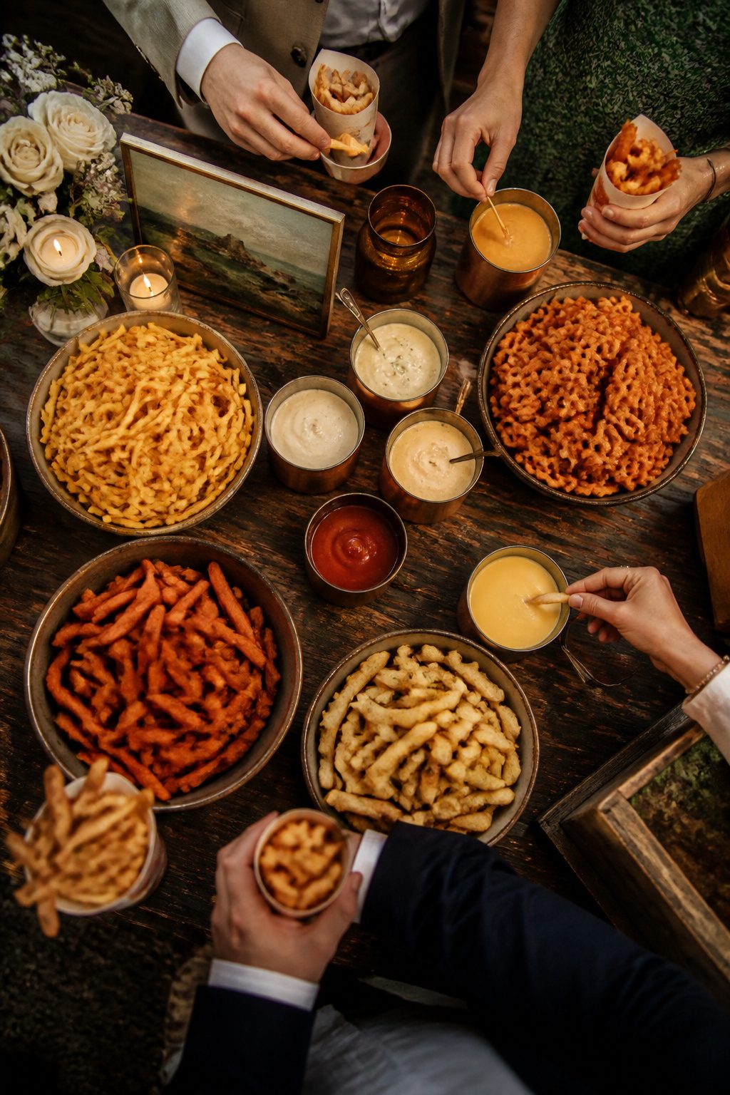 24 Wedding Station Ideas for 2026 Receptions 8 Bowls of French fries with various sauces available.