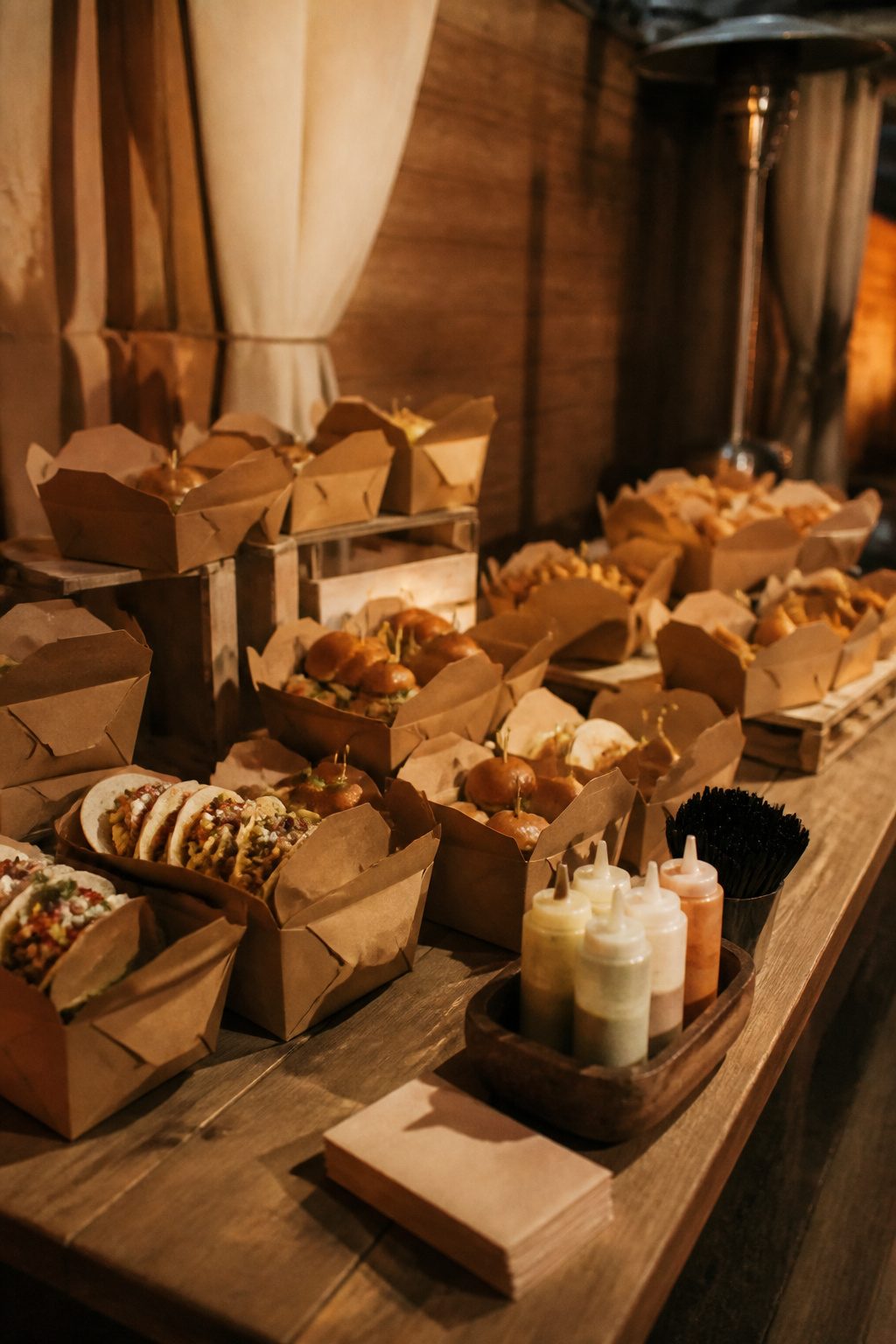 24 Wedding Station Ideas for 2026 Receptions 22 Branded boxes filled with mini tacos and sliders displayed.