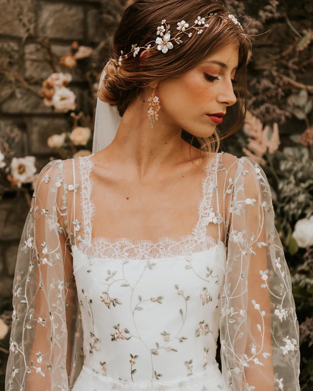 20 Spring Wedding Theme Ideas for 2026 20 Woman in a white floral embroidered wedding dress wearing a delicate flower headband.